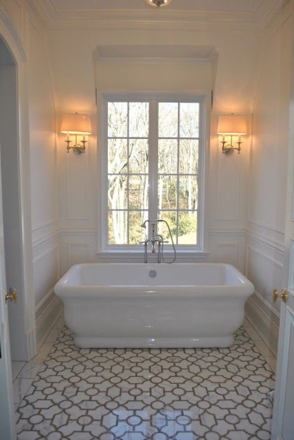 Love the tub and moulding on the walls