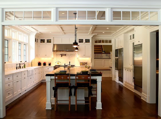 Transom windows define the space between a kitchen and living area