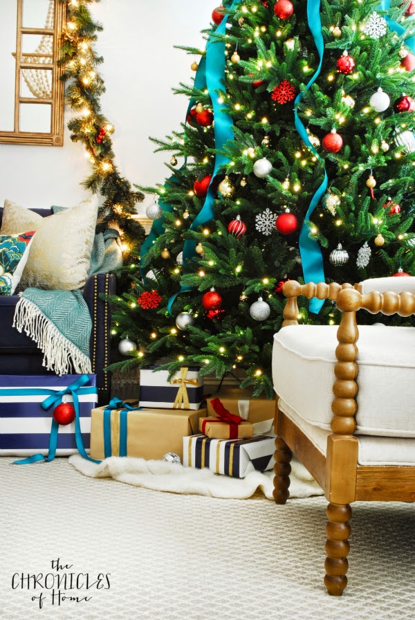 An updated classic Christmas living room - red, gold, silver, and greenery with navy and peacock blue accentsAn updated classic Christmas living room - red, gold, silver, and greenery with navy and peacock blue accents
