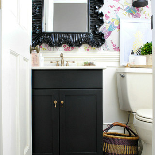 Powder room with Idira Damson peacock wallpaper, black, pink, gold, and purple accents