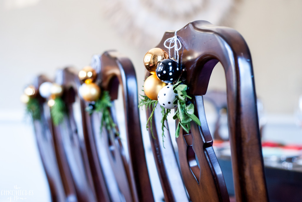 Easy idea for Christmas - hang a mini cluster and some greenery clippings on dining chairs for a pretty and festive look!