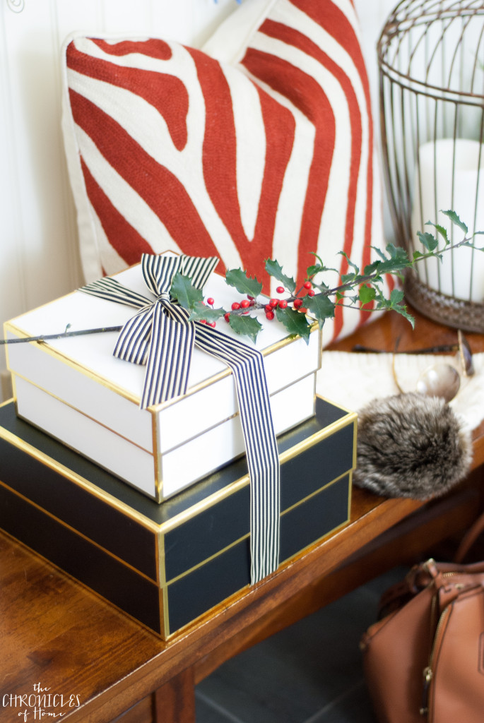 A classic family home shown decorated for Christmas with lots of black, white, red, and gold.