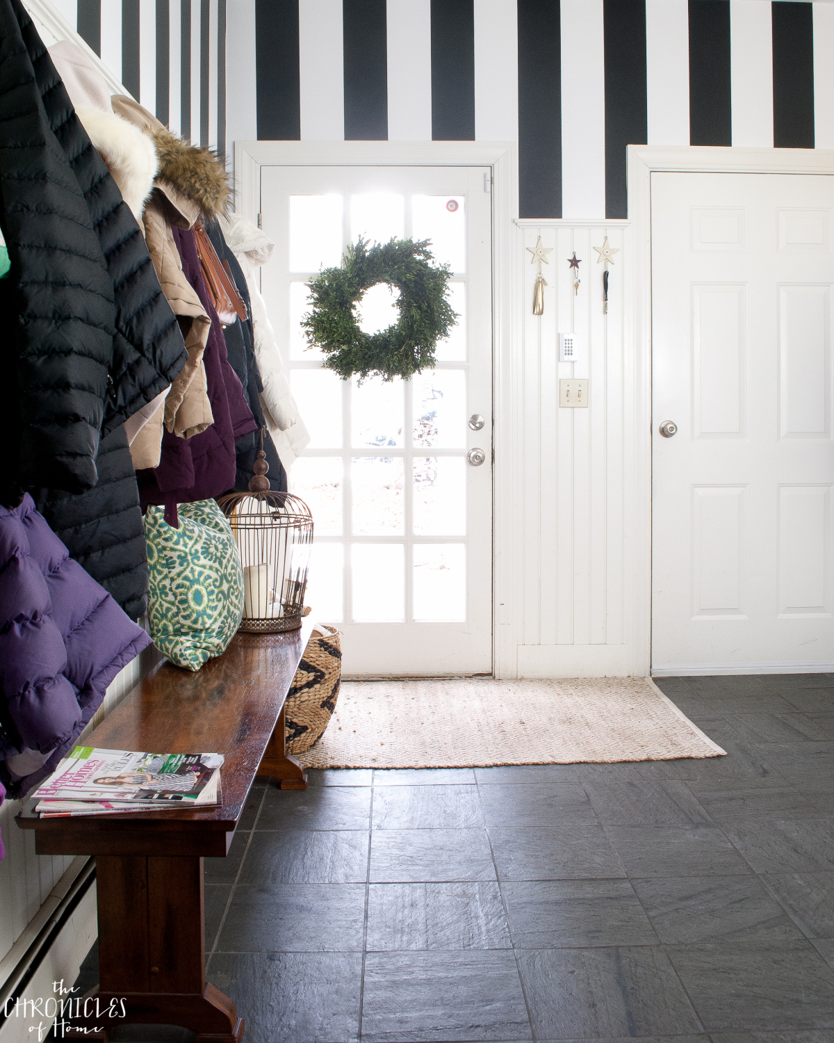 black and white striped wallpaper in a mudroom - classic and bold