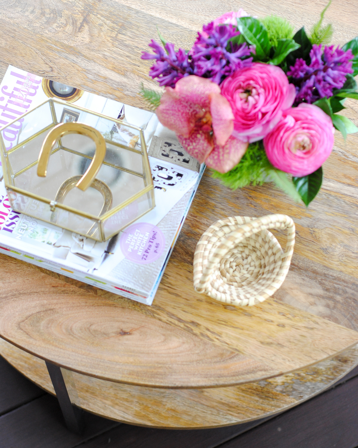 Screened porch with woven wicker, round coffee table, navy blue and pink accents - classic with a touch of contemporary!