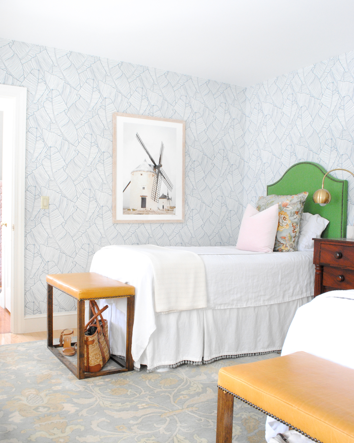 Beautiful classic, contemporary guest room with lots of DIY touches. Kelly green headboard, blue and white wallpaper, yellow leather bedroom bench.