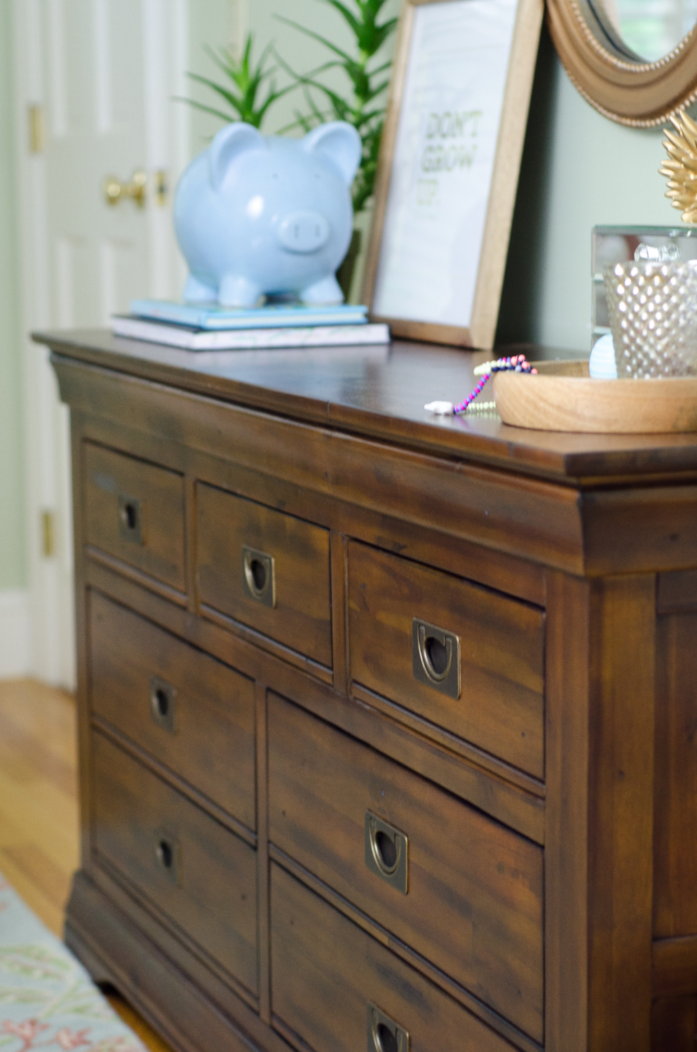 Hardwood dresser with campaign pulls (SUPER affordable) in a darling girl's bedroom