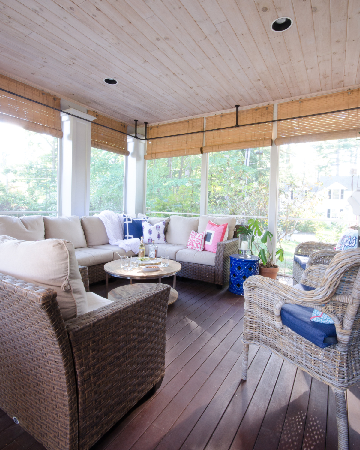Stunning classic screened porch with pink, navy blue, and white.