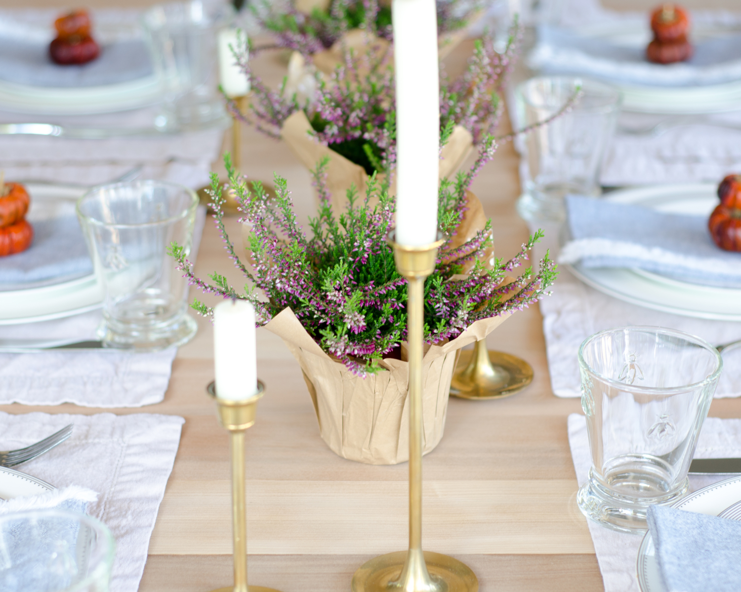 Simple, classic fall table with brass, navy blue, white, purple, and deep orange.