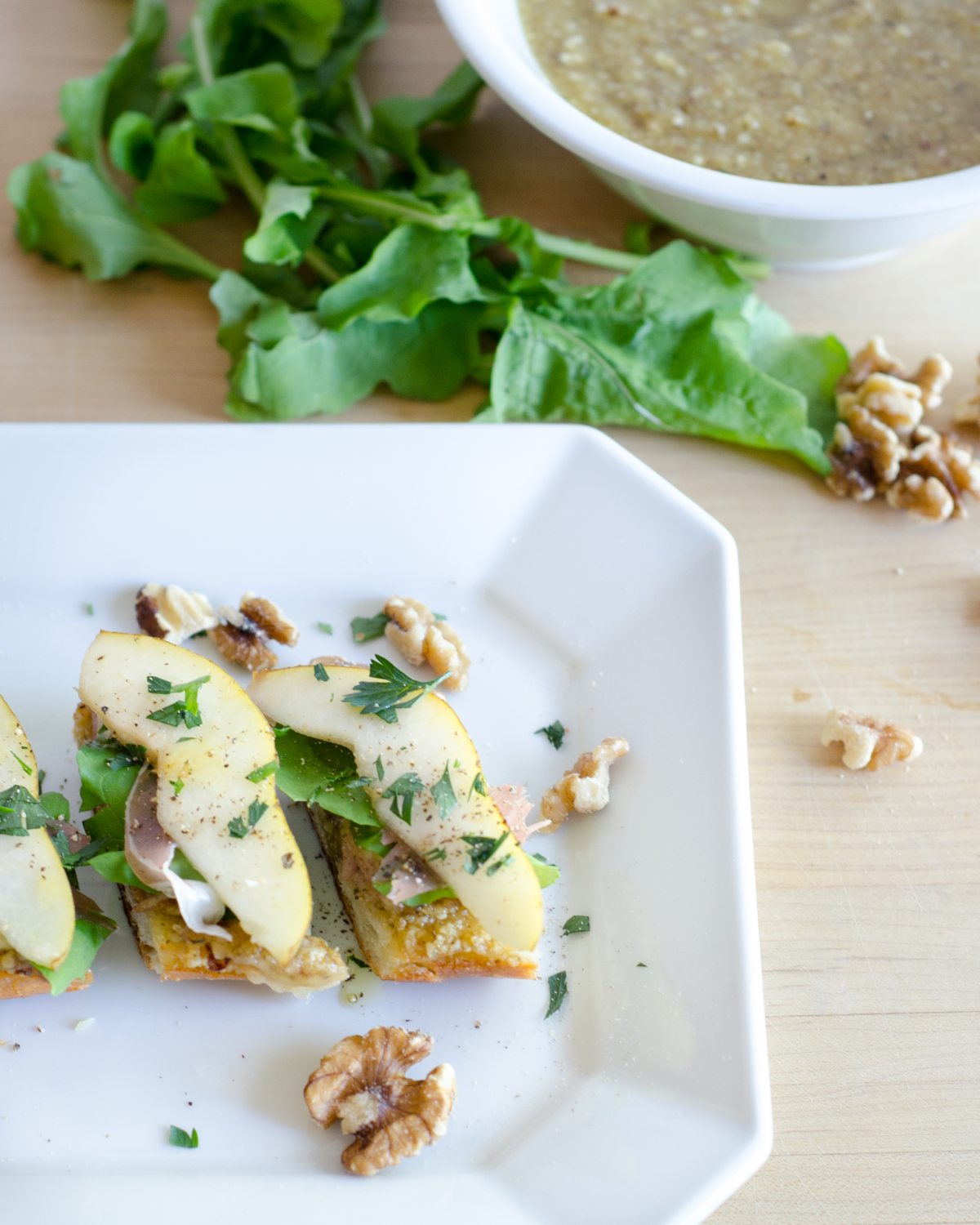 Crazy good fall appetizer - crostini with sweet and salty walnut pesto, pears, prosciutto, and Havarti cheese. To die for!!