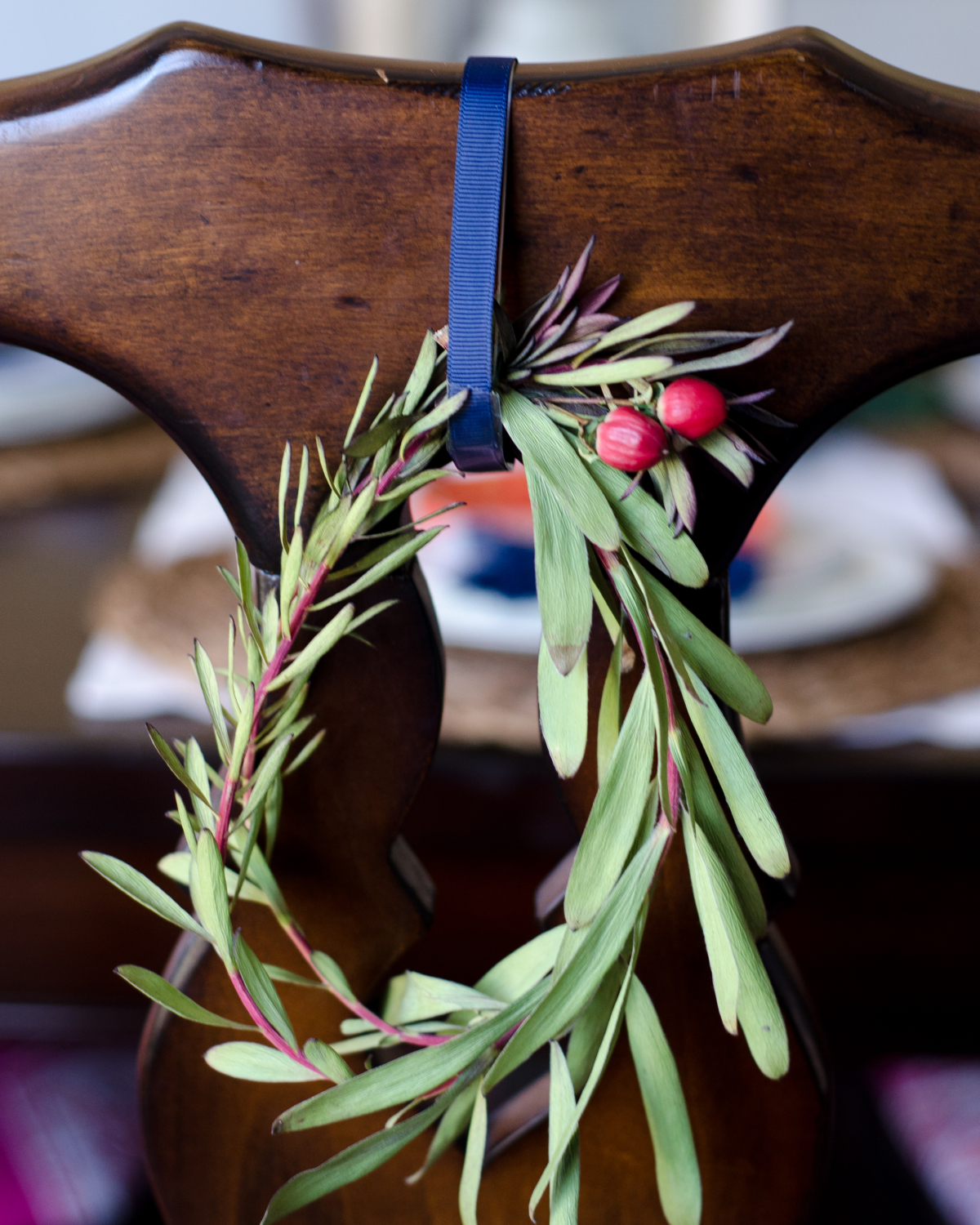 Easy Christmas decorating - miniature wreaths hung on the backs of dining room chairs