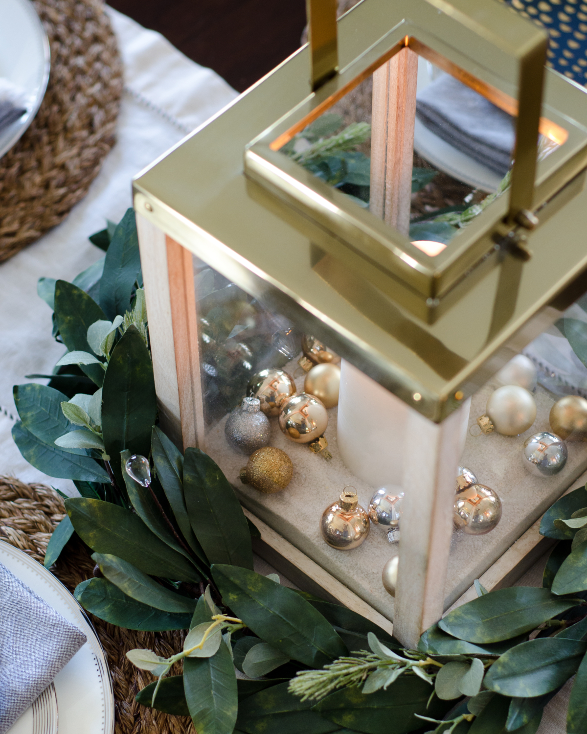 Simple Christmas centerpiece - candle lanterns filled with decorative sand and miniature ball ornaments