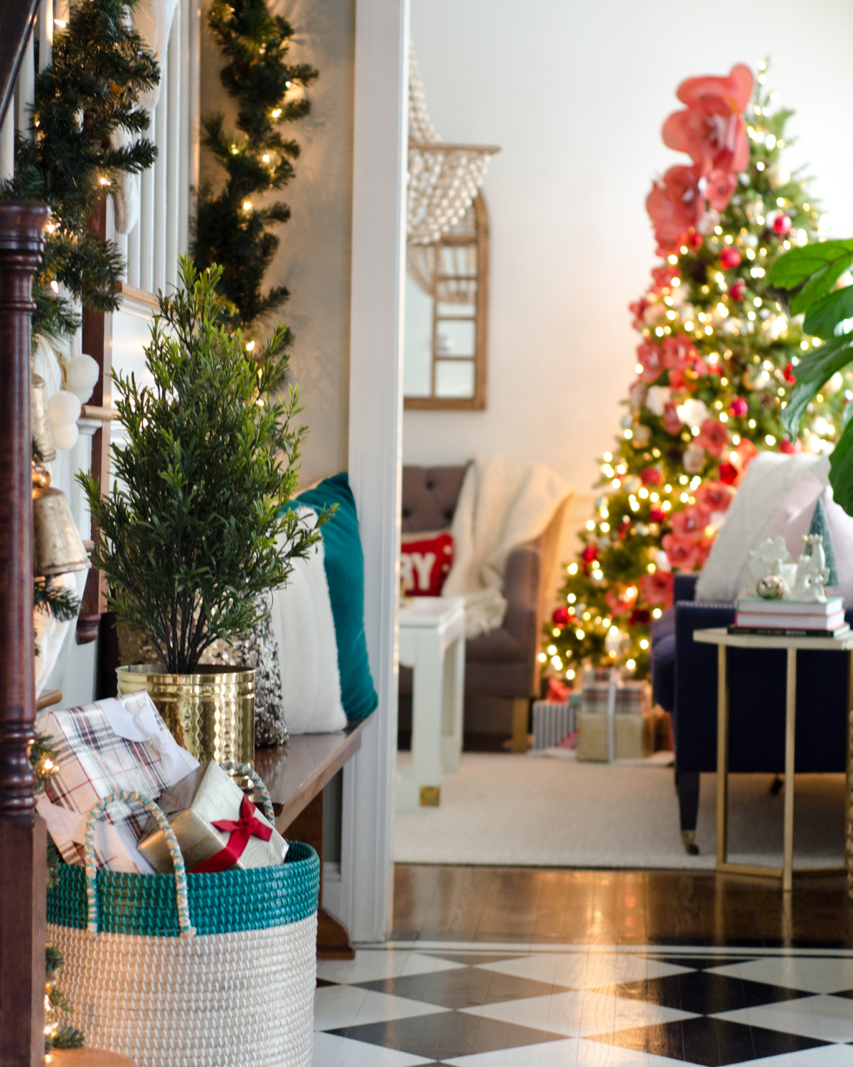 Classic Christmas entryway with greenery, twinkle lights, cable knit stockings, and more! So much inspiration!!