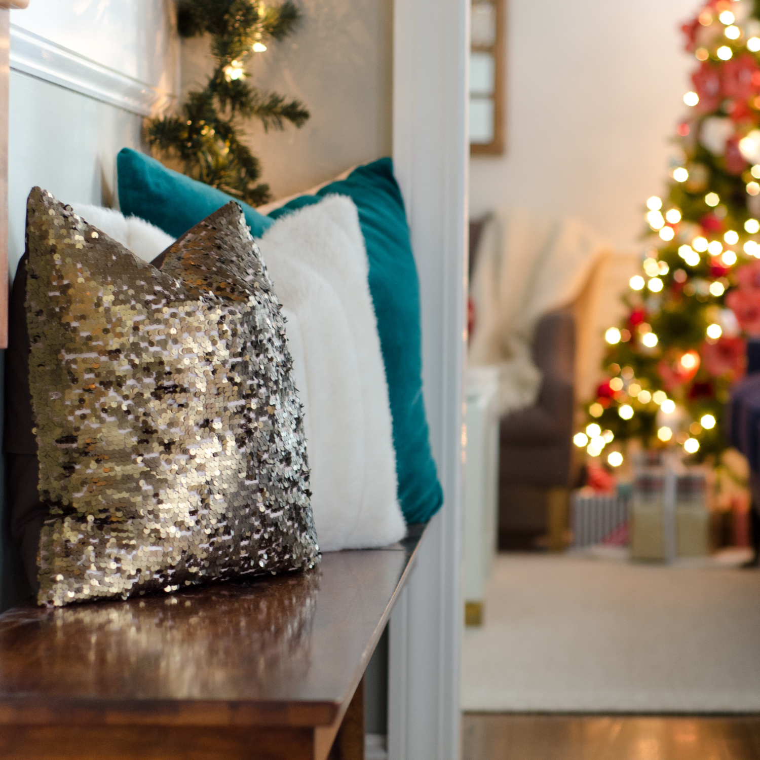 Classic Christmas entryway with greenery, twinkle lights, cable knit stockings, and more! So much inspiration!!