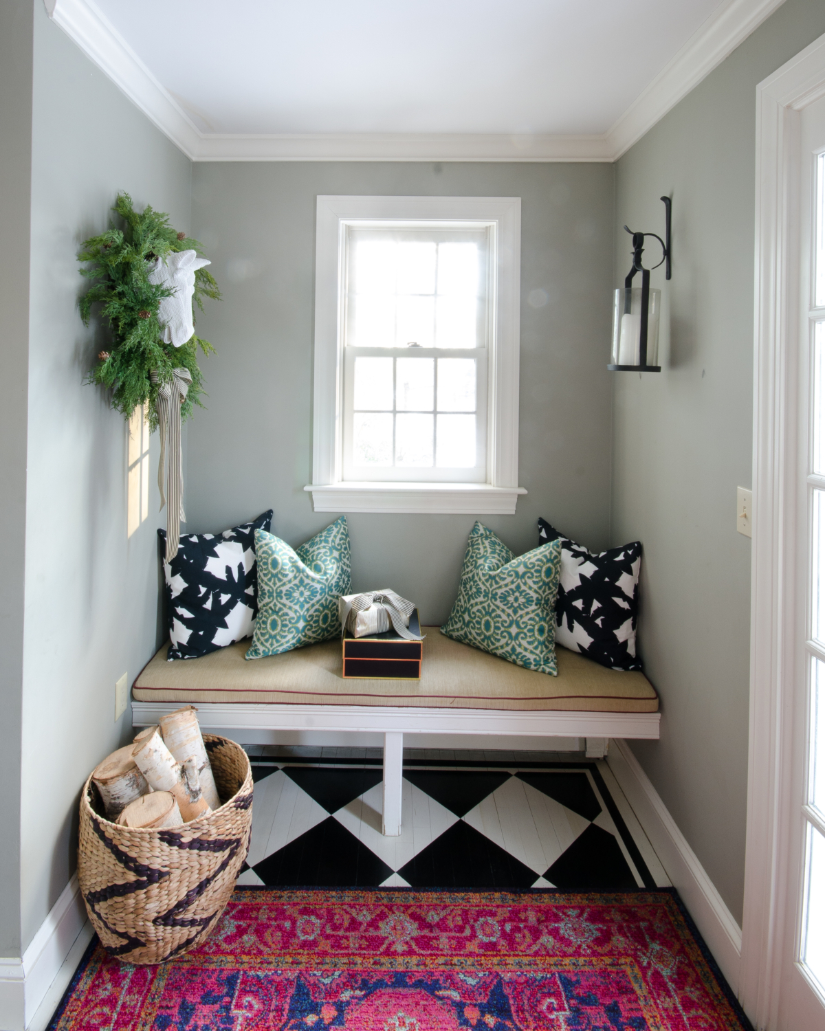 Classic Christmas entryway with greenery, twinkle lights, cable knit stockings, and more! So much inspiration!!