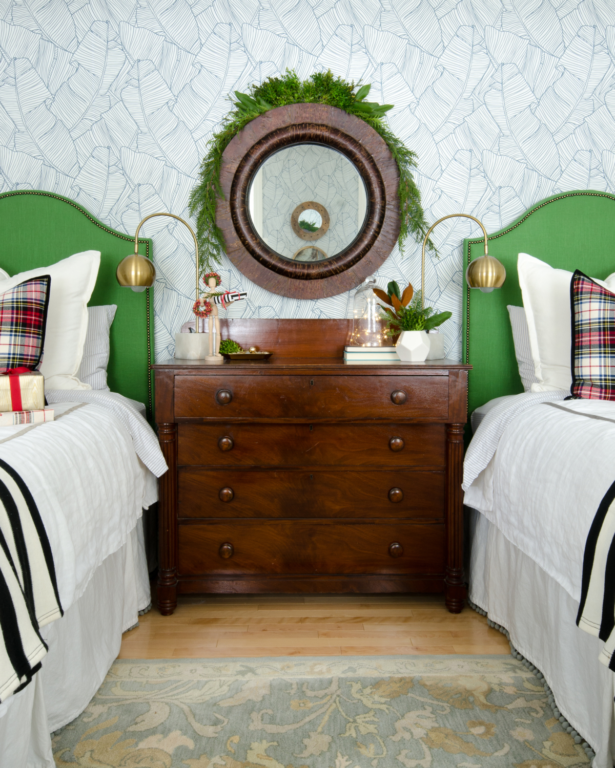 Classic Christmas guest room with custom DIY upholstered headboards, red plaid pillows, fresh greenery, and cute, quirky accents. Perfect way to make Christmas guest feel at home!