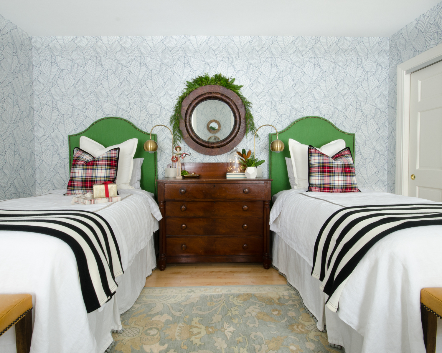 Classic Christmas guest room with custom DIY upholstered headboards, red plaid pillows, fresh greenery, and cute, quirky accents. Perfect way to make Christmas guest feel at home!