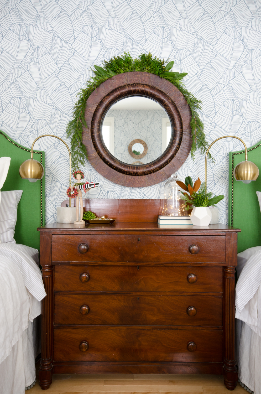 Classic Christmas guest room with custom DIY upholstered headboards, red plaid pillows, fresh greenery, and cute, quirky accents. Perfect way to make Christmas guest feel at home!
