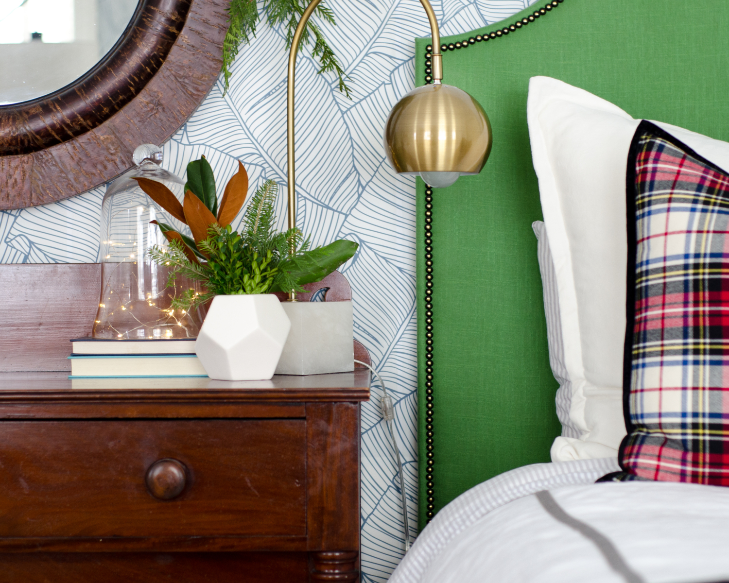 Classic Christmas guest room with custom DIY upholstered headboards, red plaid pillows, fresh greenery, and cute, quirky accents. Perfect way to make Christmas guest feel at home!