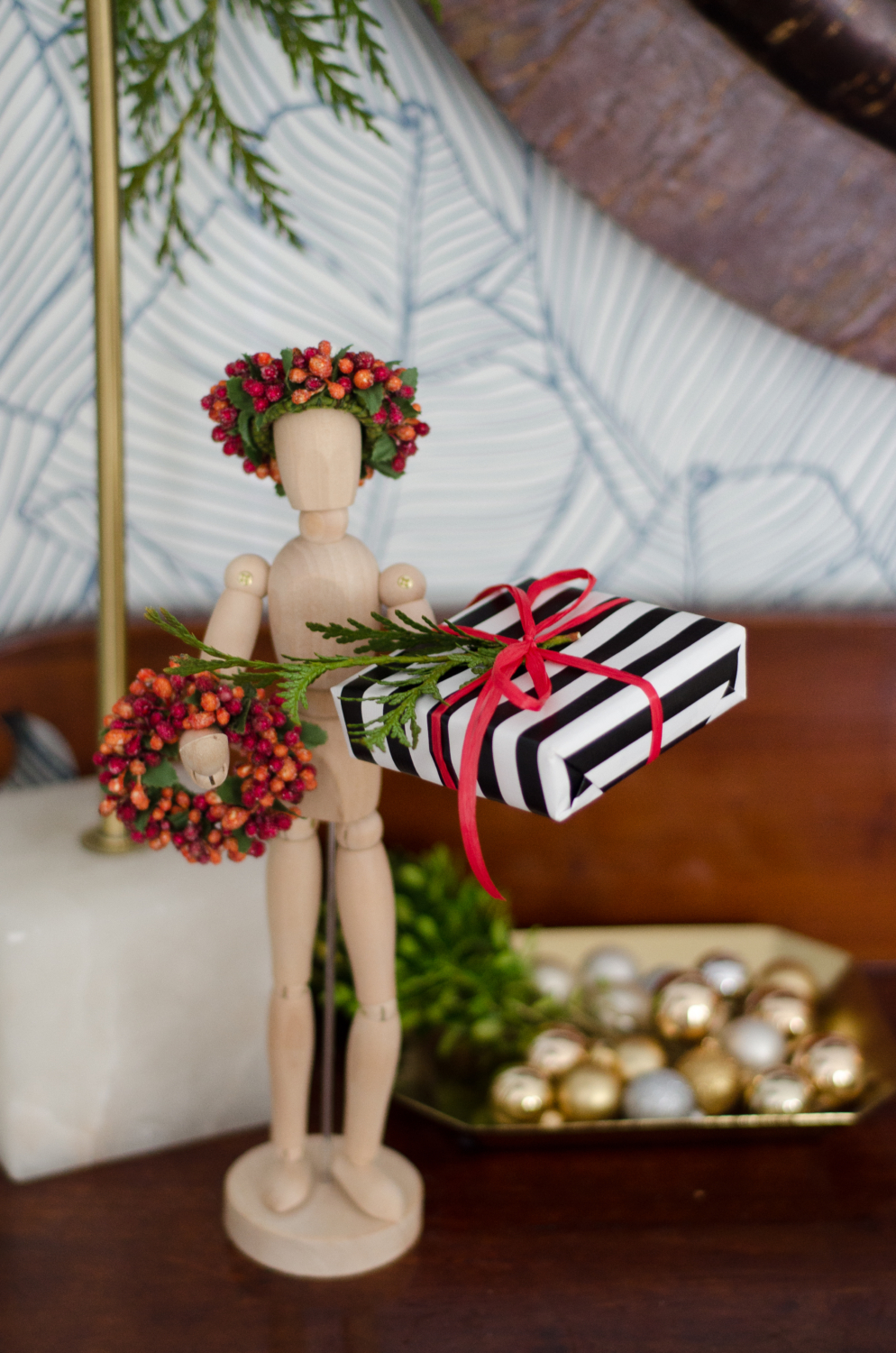 Classic Christmas guest room with custom DIY upholstered headboards, red plaid pillows, fresh greenery, and cute, quirky accents. Perfect way to make Christmas guest feel at home!