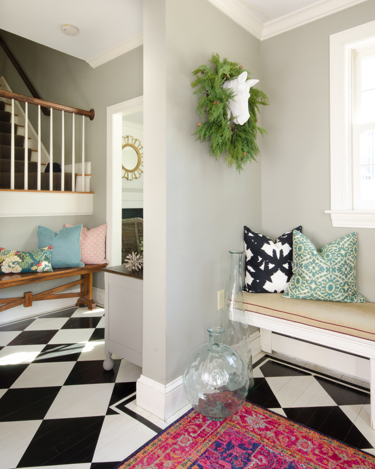 A charming, fresh entryway design featuring black and white, deep pink, and teal blue accents.