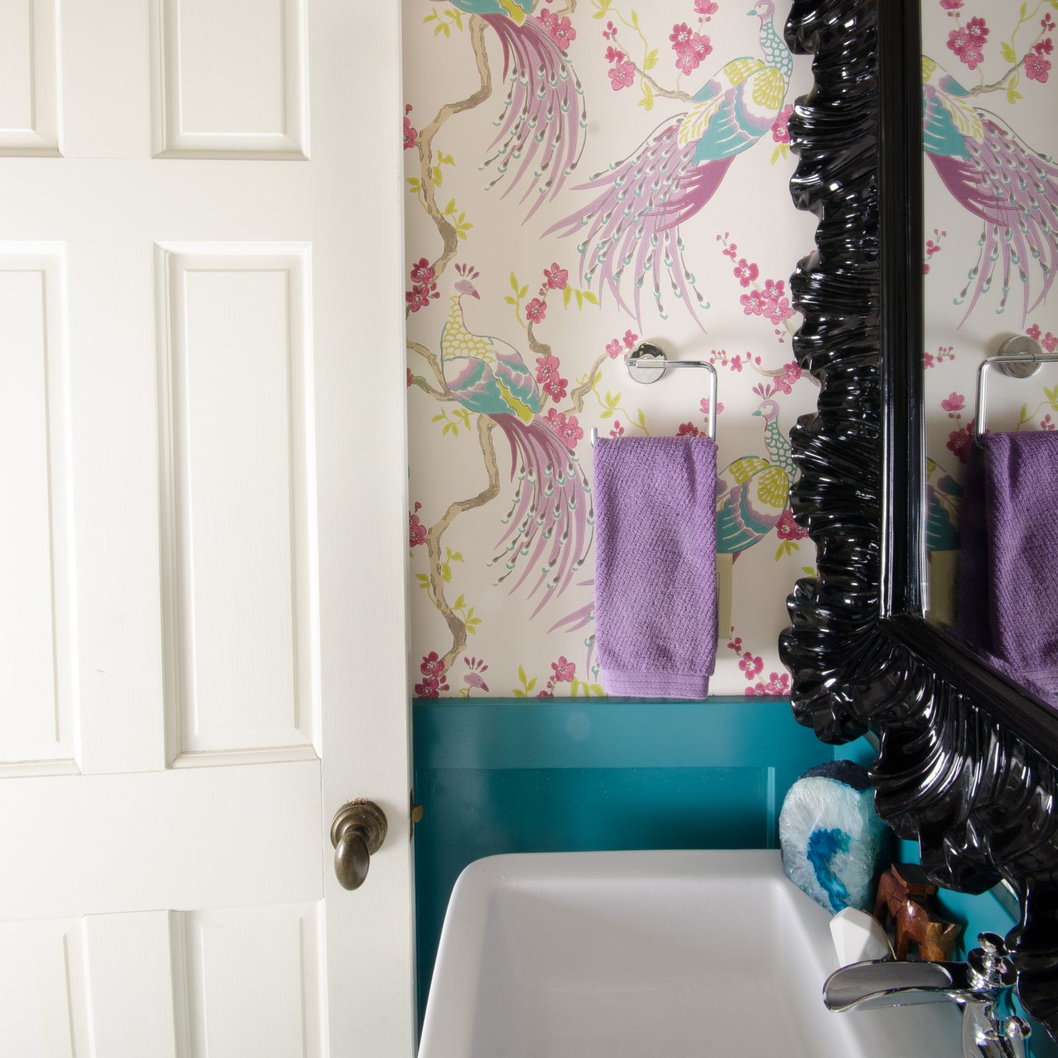 Small powder room with amazing bird wallpaper and teal blue wainscoting