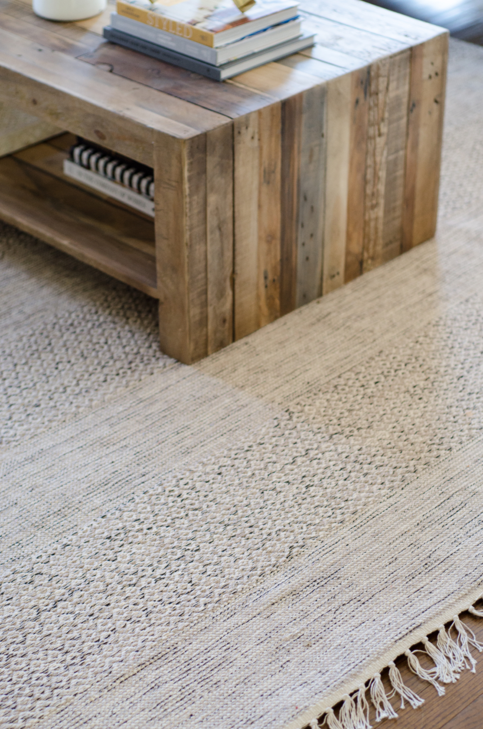 A family friendly rug made of flat weave cotton is shades of beige and grey.