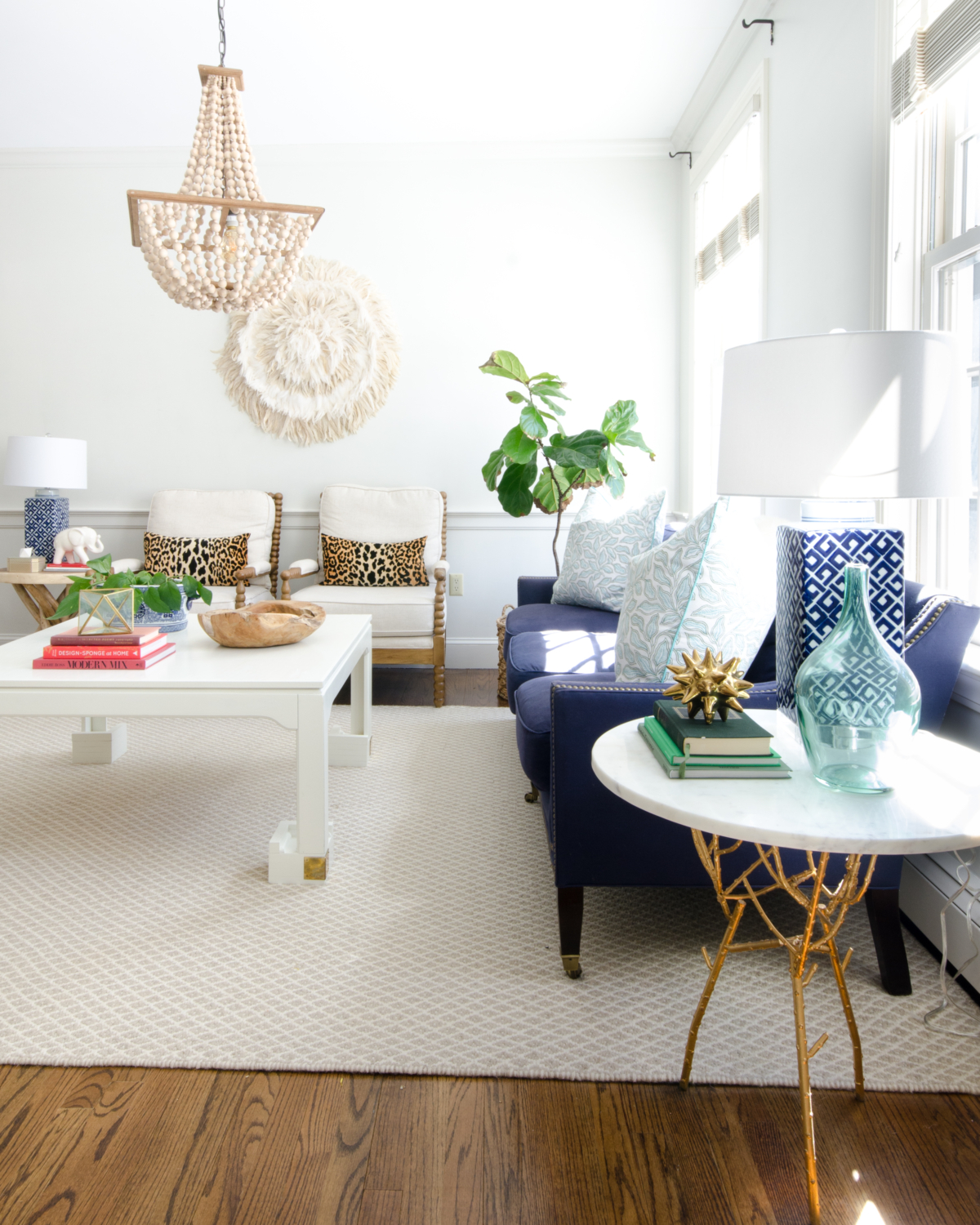 Spring decorating ideas in a classic living room with neutral base pieces and a variety of blue accents.