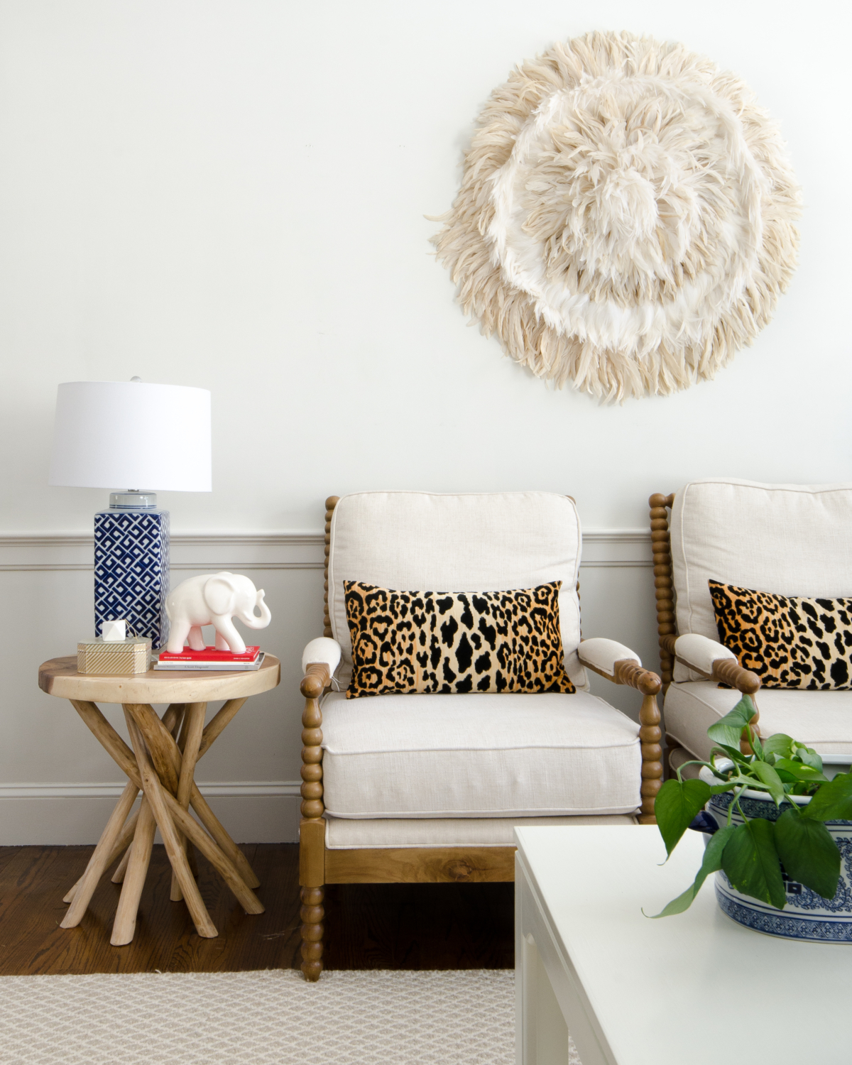 DIY feather wall hanging juju hat, spool chairs, Braemore Jamil Natural leopard pillows, rustic branch table