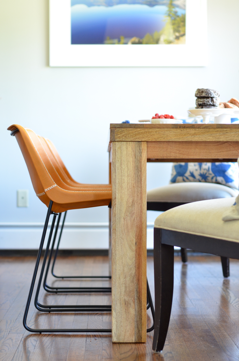 Leather side chairs in a breakfast nook makeover in process. Stylish, kid-friendly dining chairs can be hard to find but these small-scale beauties fit the bill!