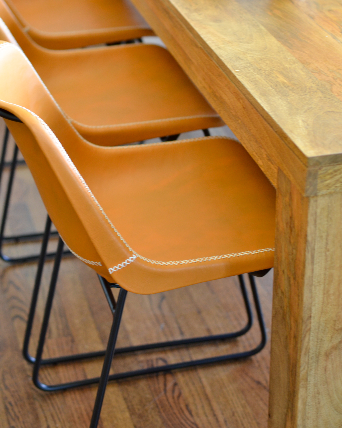 Leather side chairs in a breakfast nook makeover in process. Stylish, kid-friendly dining chairs can be hard to find but these small-scale beauties fit the bill!