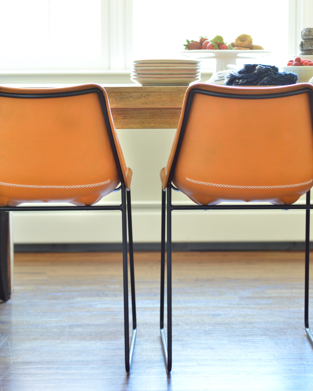 Leather side chairs in a breakfast nook makeover in process. Stylish, kid-friendly dining chairs can be hard to find but these small-scale beauties fit the bill!