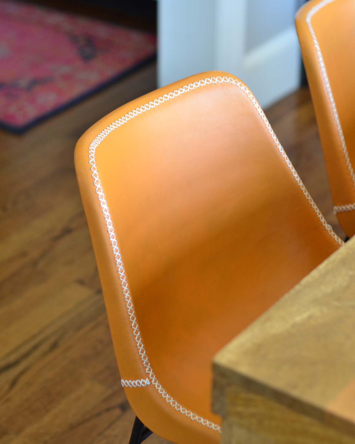 Leather side chairs in a breakfast nook makeover in process. Stylish, kid-friendly dining chairs can be hard to find but these small-scale beauties fit the bill!