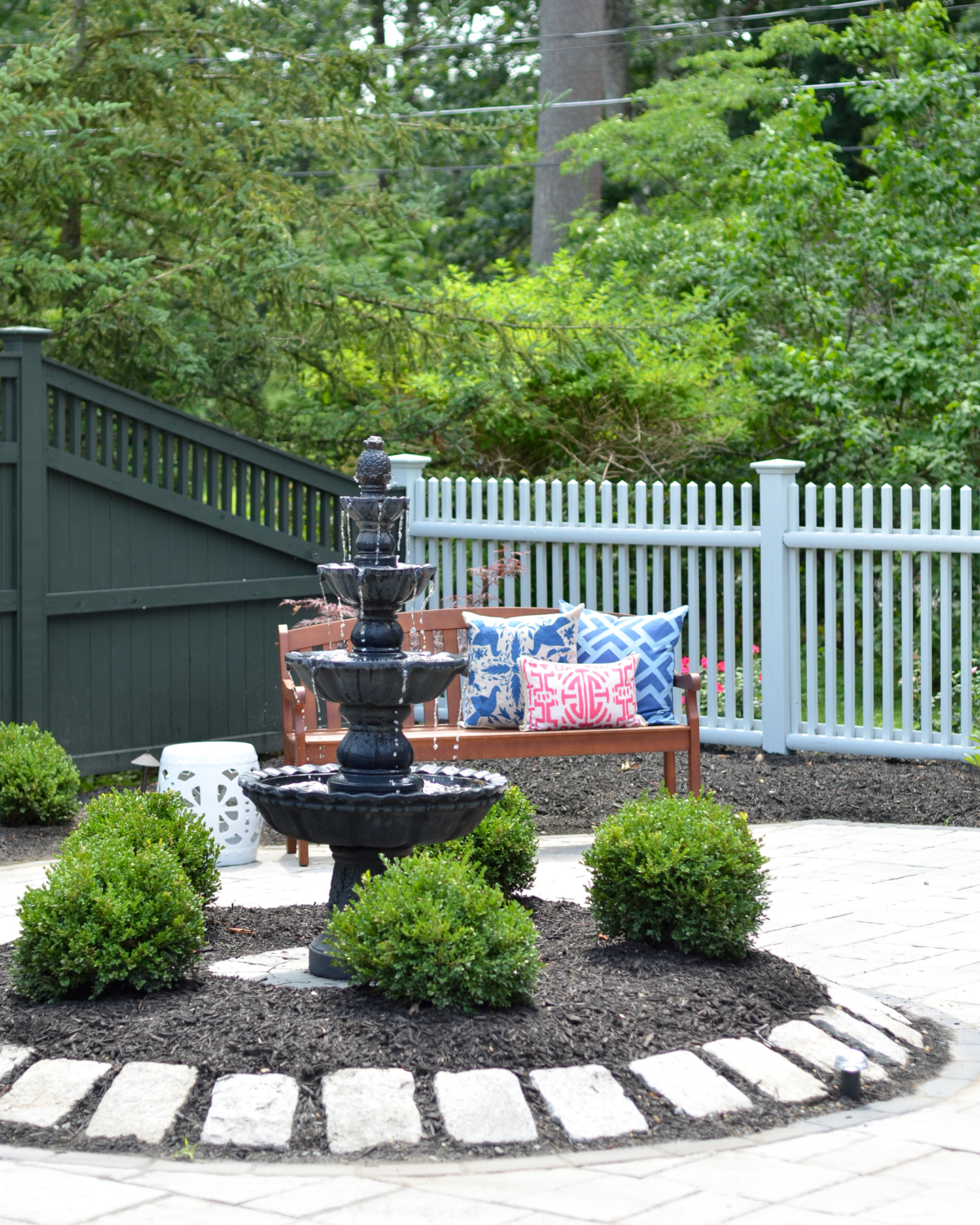 Custom paver patio with a fountain at the center, classic outdoor living space ideas for decorating your deck or patio