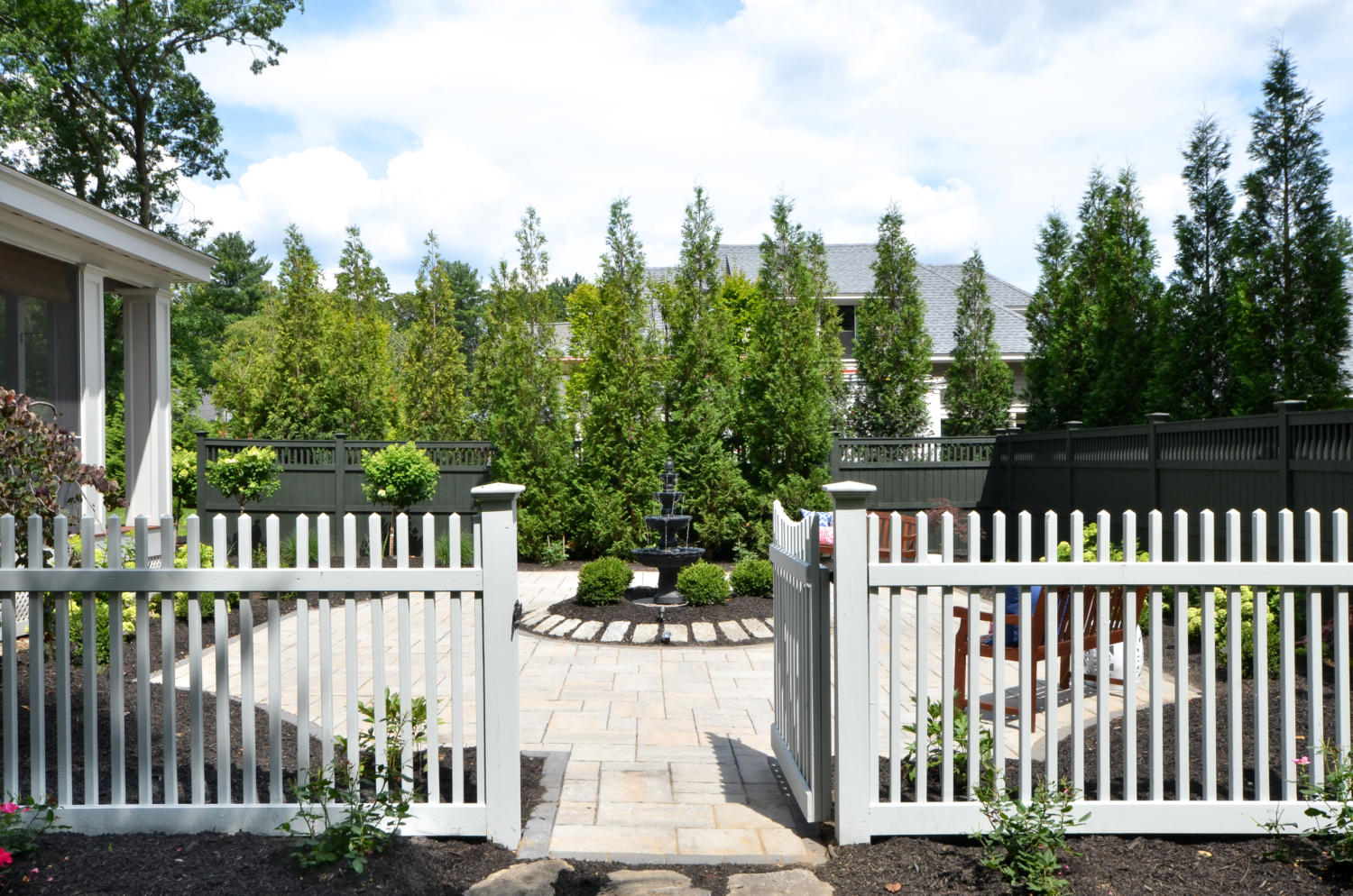 Custom paver patio with a fountain at the center, classic outdoor living space ideas for decorating your deck or patio