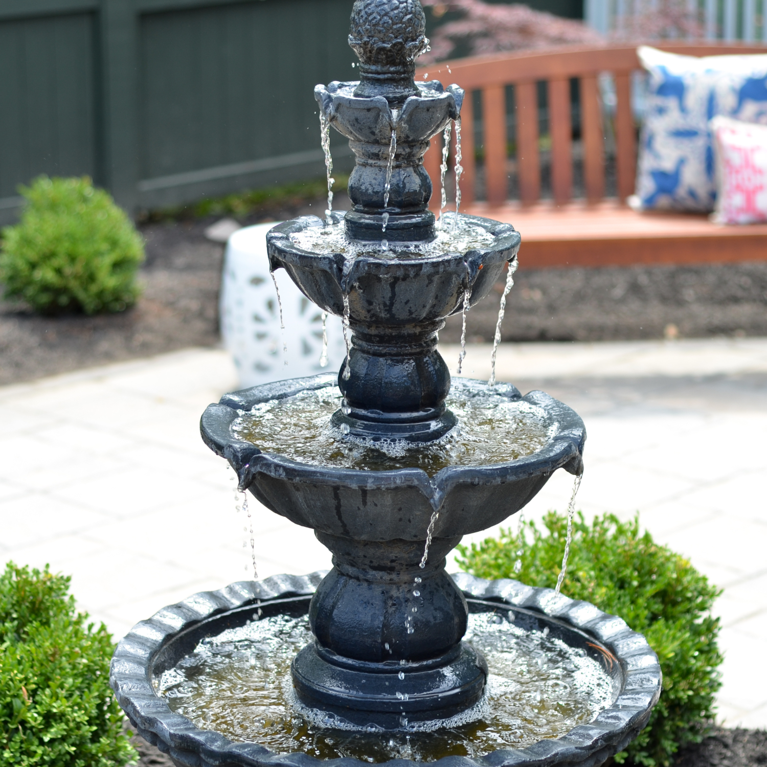 Custom paver patio with a fountain at the center, classic outdoor living space ideas for decorating your deck or patio