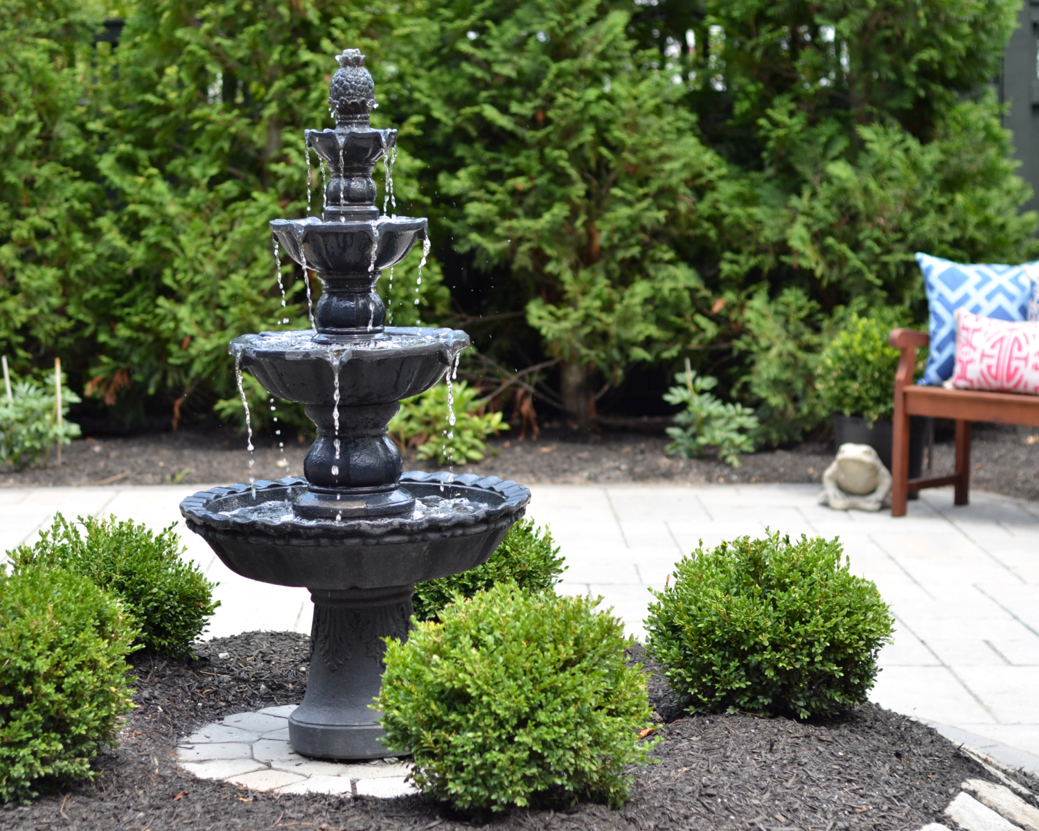 Custom paver patio with a fountain at the center, classic outdoor living space ideas for decorating your deck or patio