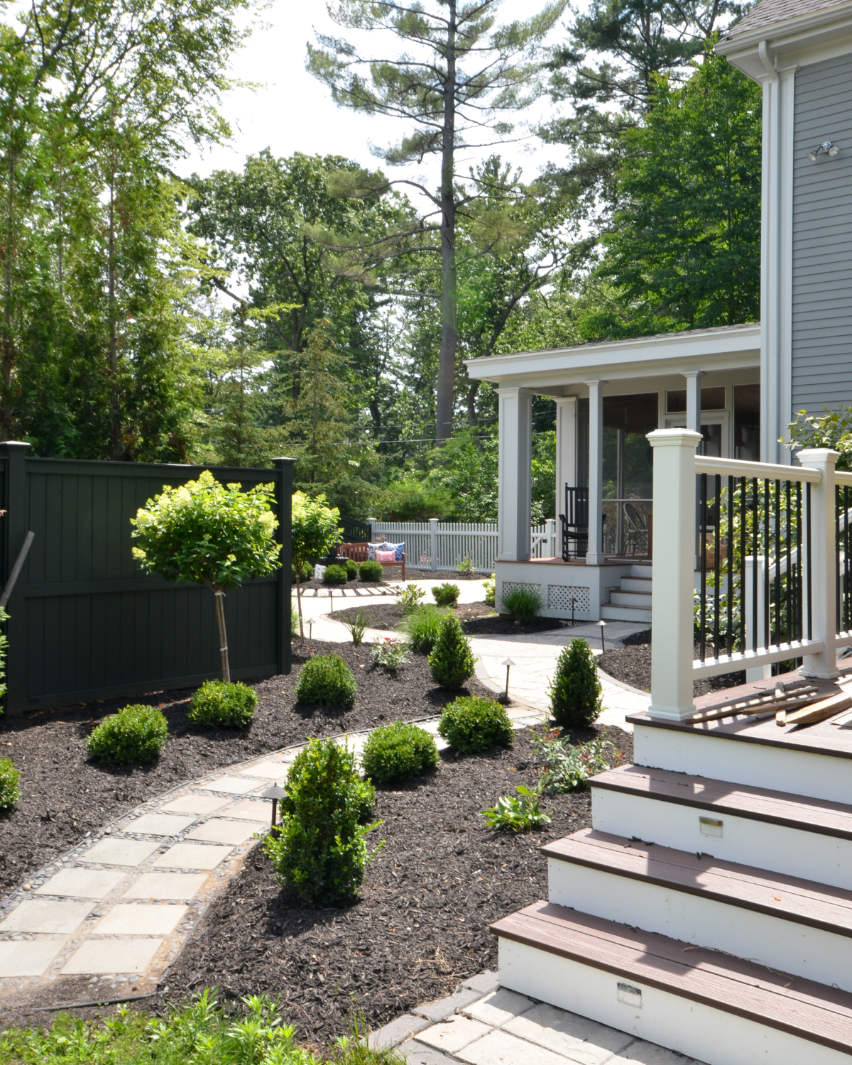 Amazing backyard landscaping makeover that includes a Trex deck, a paver patio with gas firepit, and a paver patio with a fountain and benches. So much outdoor inspiration!