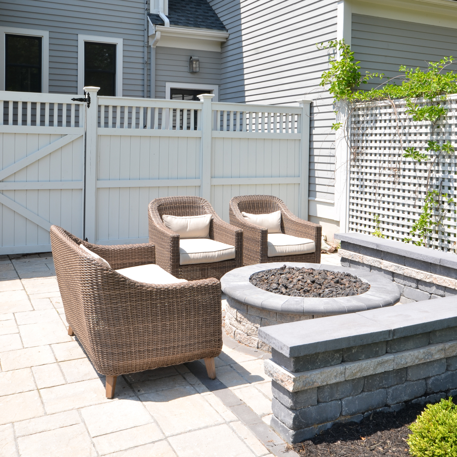 Amazing backyard landscaping makeover that includes a Trex deck, a paver patio with gas firepit, and a paver patio with a fountain and benches. So much outdoor inspiration!