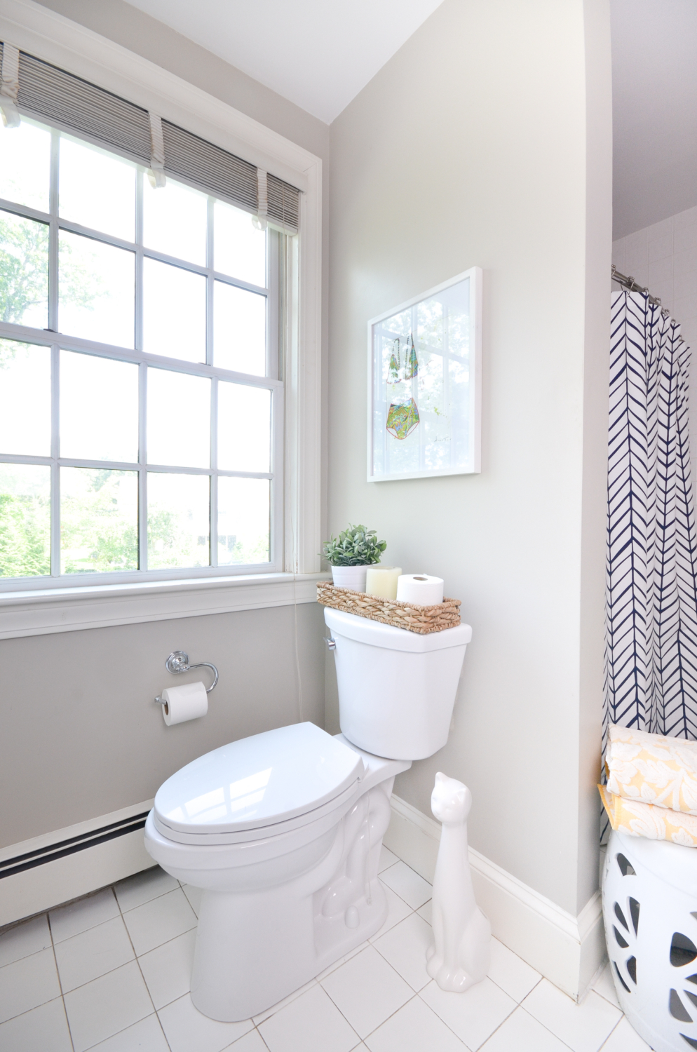 Easy tips for a clean bathroom that you can use everyday, plus sources for this pretty, simple white and navy bathroom