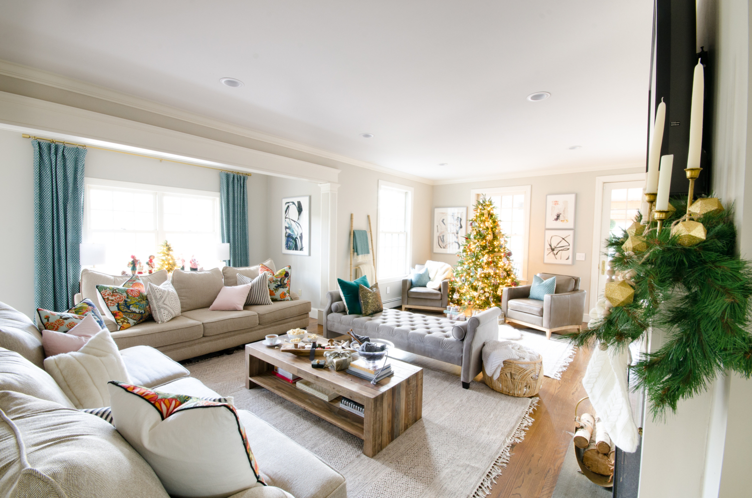 A simple and classic Christmas family room with greenery, white, and gold accents. 2017 Holiday Housewalk