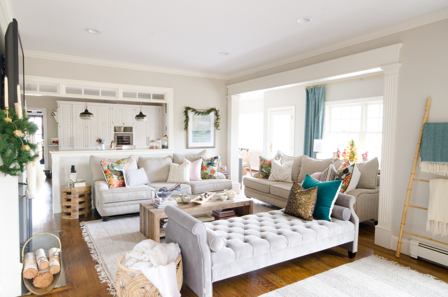 A simple and classic Christmas family room with greenery, white, and gold accents. 2017 Holiday Housewalk