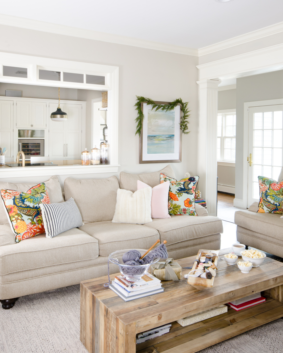 A simple and classic Christmas family room with greenery, white, and gold accents. 2017 Holiday Housewalk
