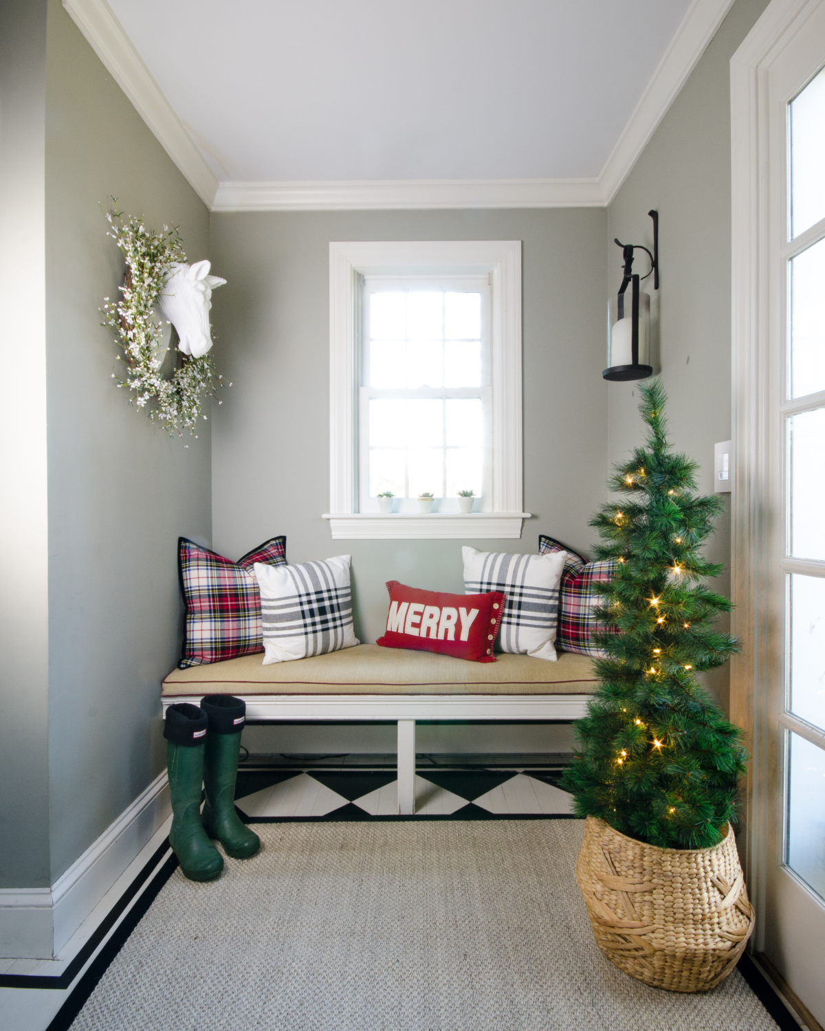Classic Christmas entry with red, black, white, and greenery
