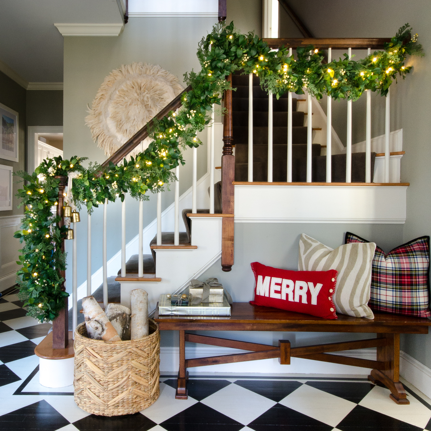 Classic Christmas entry with red, black, white, and greenery