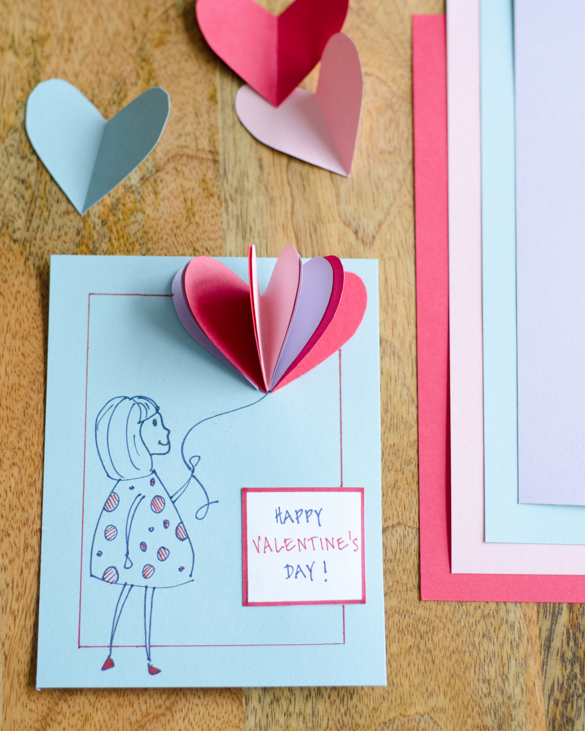 Easy DIY Valentines with 3D paper hearts. Great Valentine's craft for kids that can also be used for exchanging cards at school!