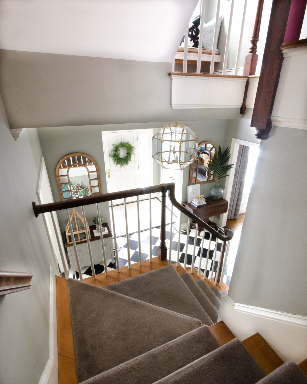 A stunning gold entryway light that is a dread ringer for the Circa Lighting Morris Lantern but at about a third of the price! Checkered floors and simple accents complete the updated classic look of this entry.