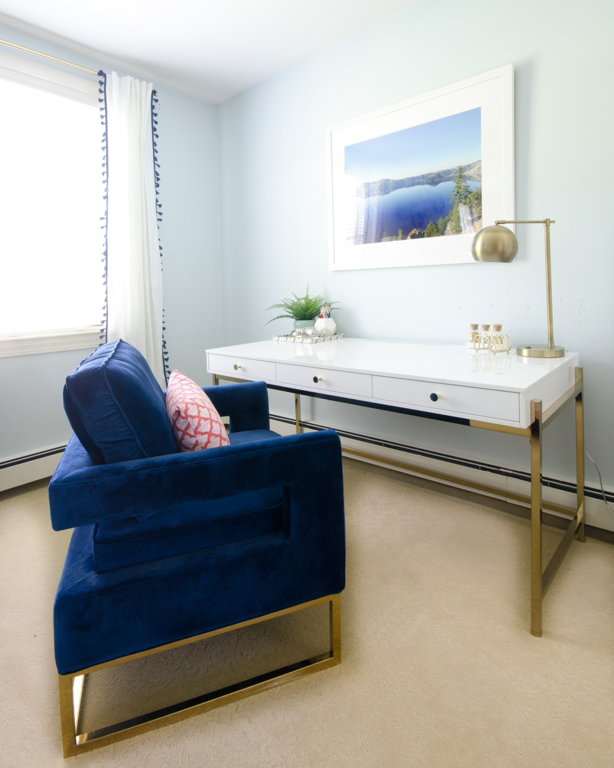 Glam desk area with blue velvet chair and white lacquered with brass accents