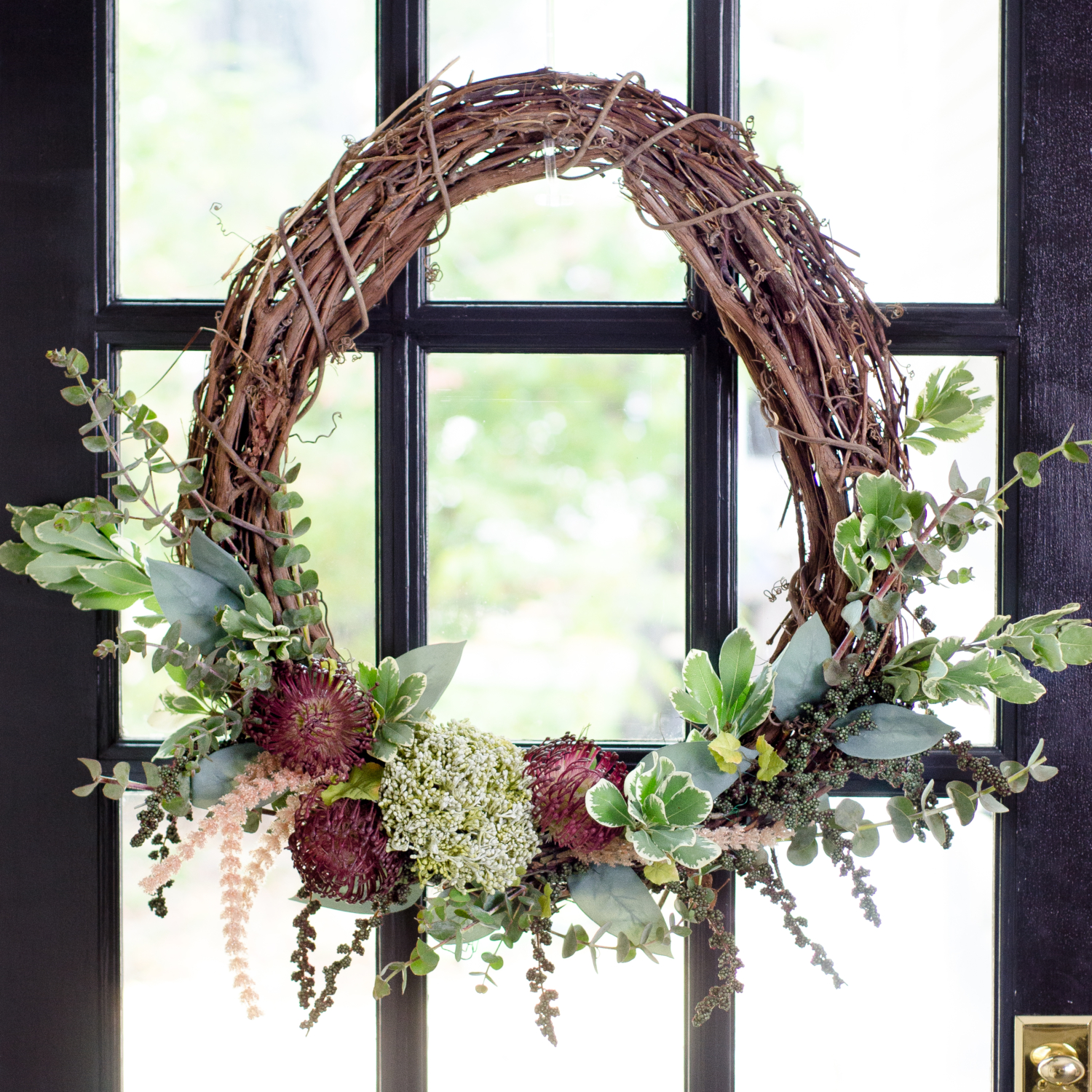 Easy, step-by-step instructions for making a DIY fall wreath with a grapevine base. Budget friendly and done in less than 30 minutes!