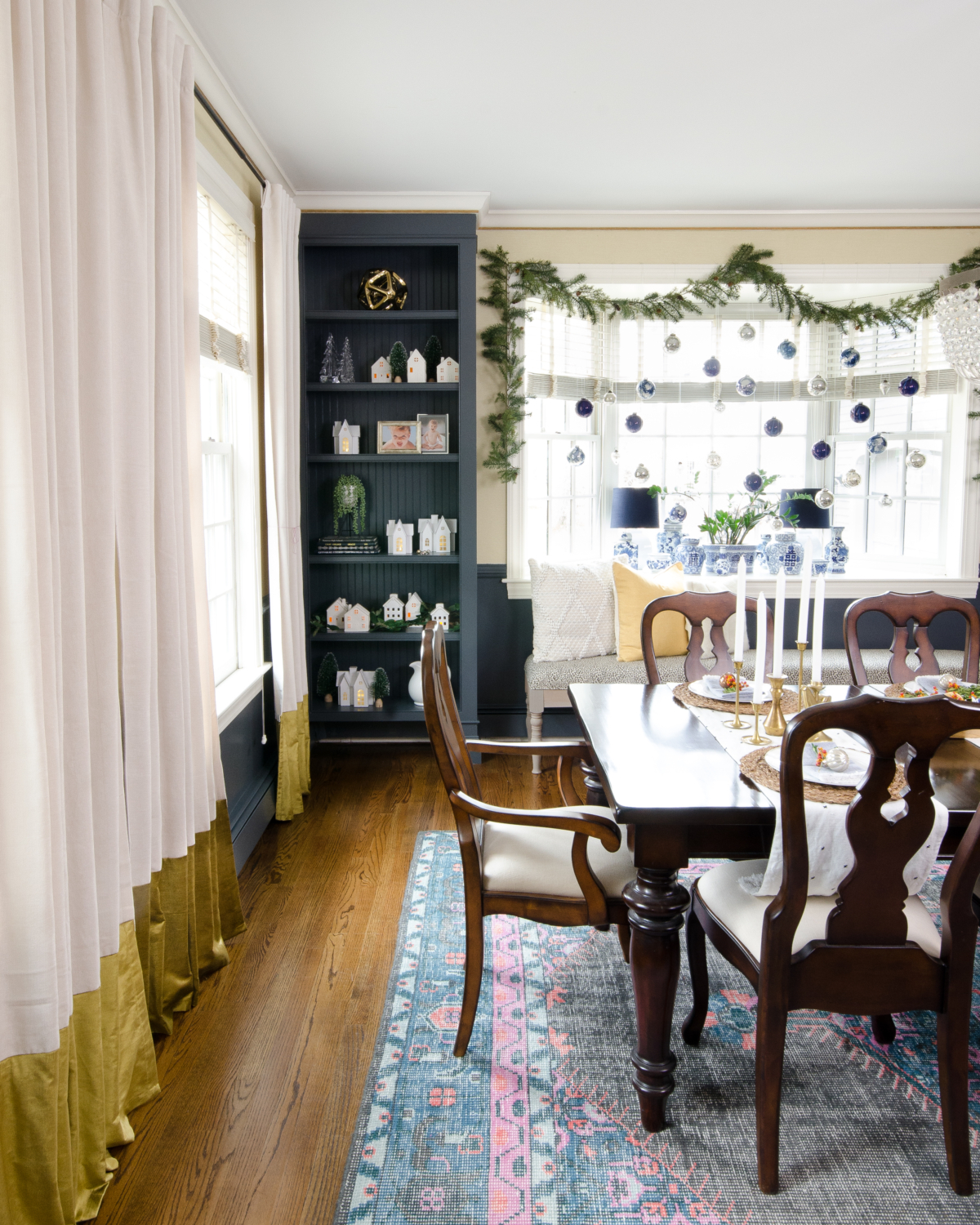 Christmas dining room with blue and white pottery, white ceramic houses, dark walls