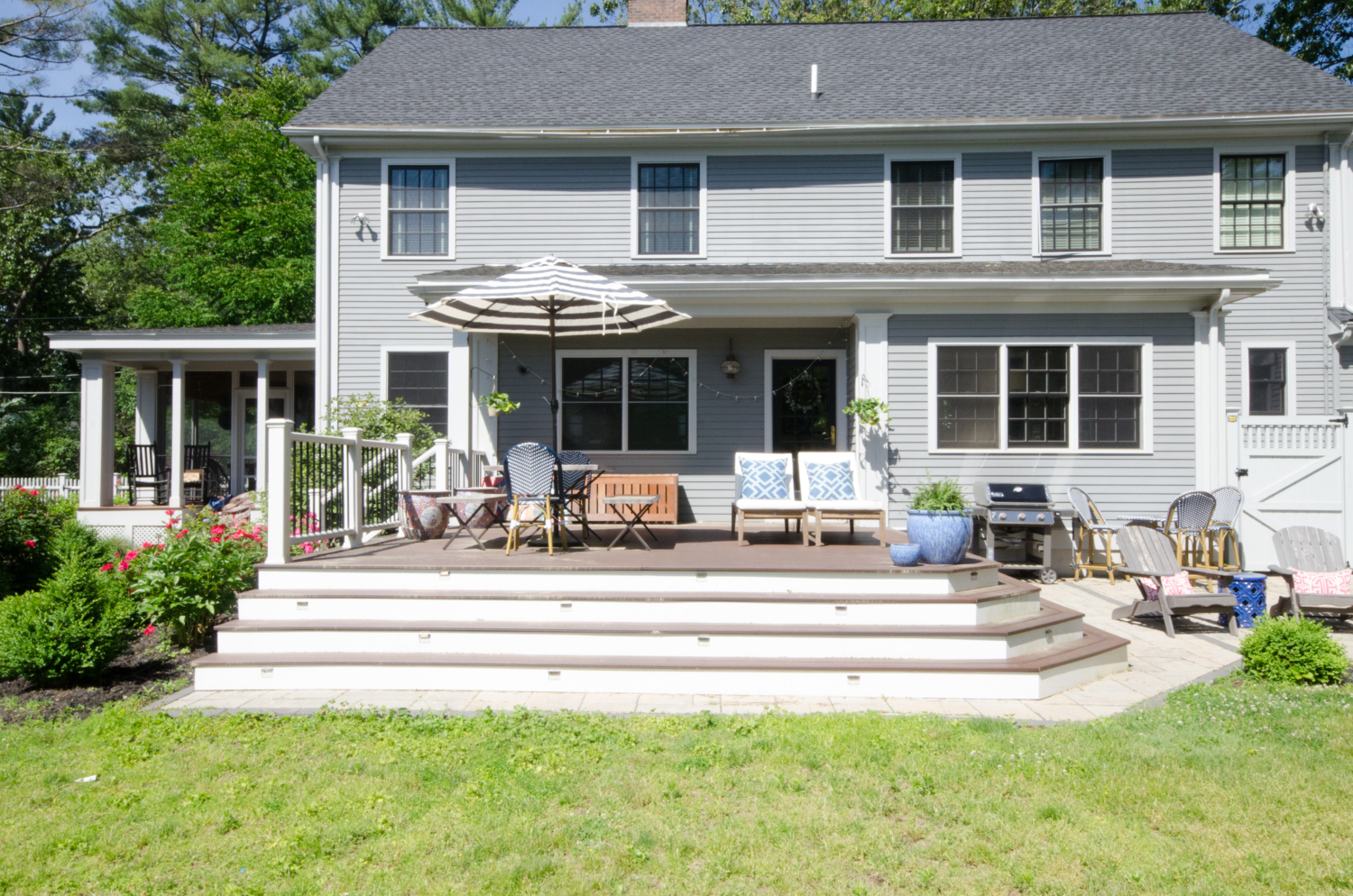 Gorgeous deck space with lush plantings, dining space, and lounge chairs.